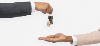 hand giving key real estate agent